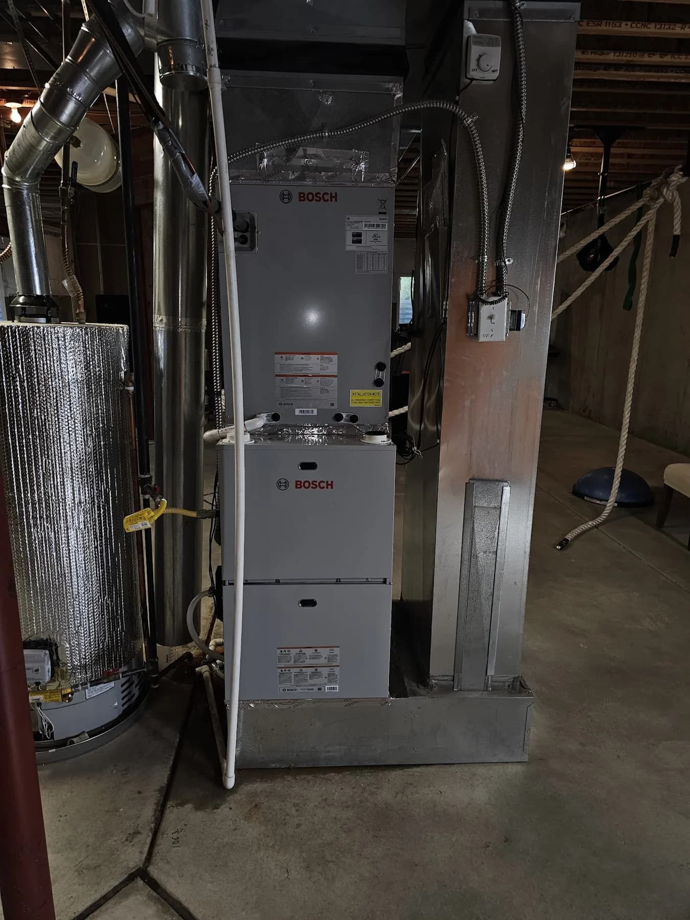 Bosch furnace and boiler equipment with visible piping and duct connections in a mechanical room