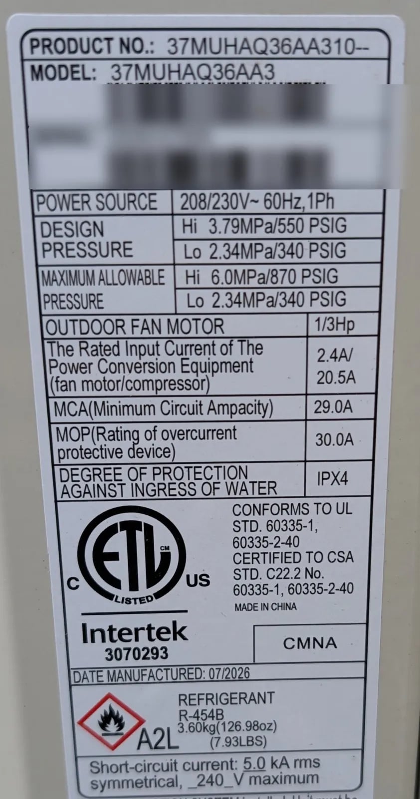 Carrier outdoor unit nameplate showing the model number, electrical ratings and R-454B refrigerant